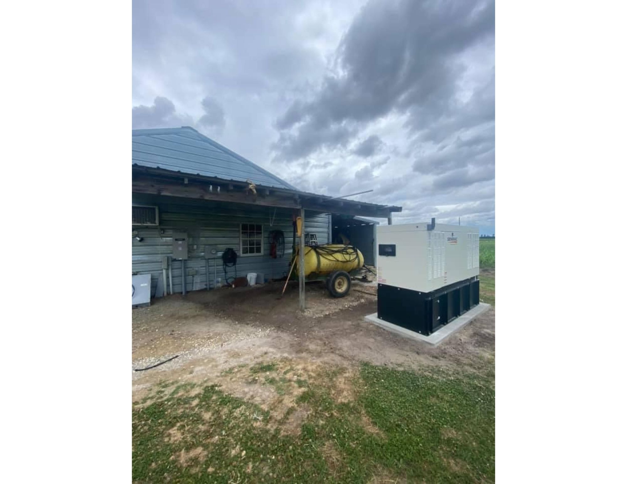 Generac generator installed at a farm building under overcast skies