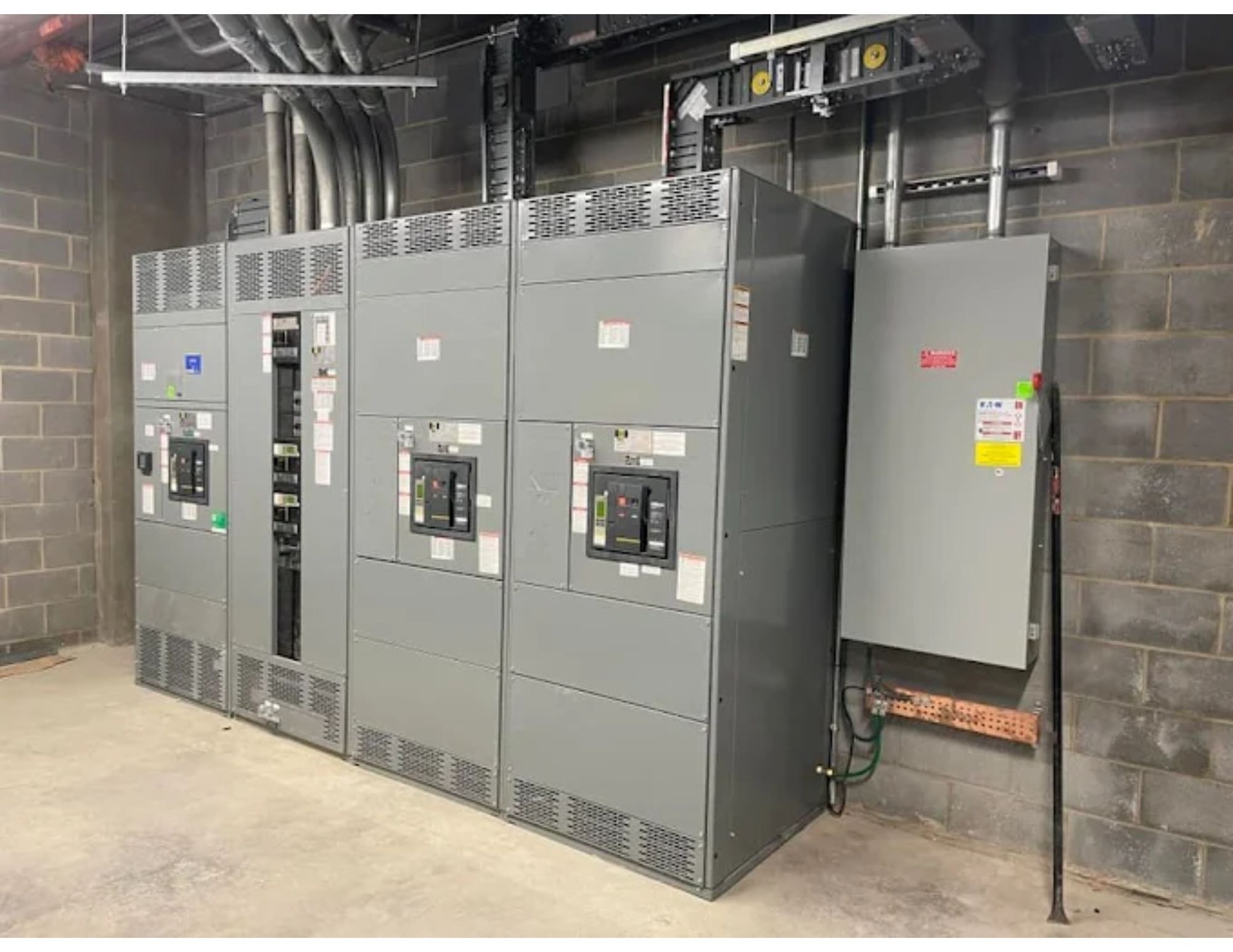 Commercial switchgear and electrical distribution panels installed in a block-wall building